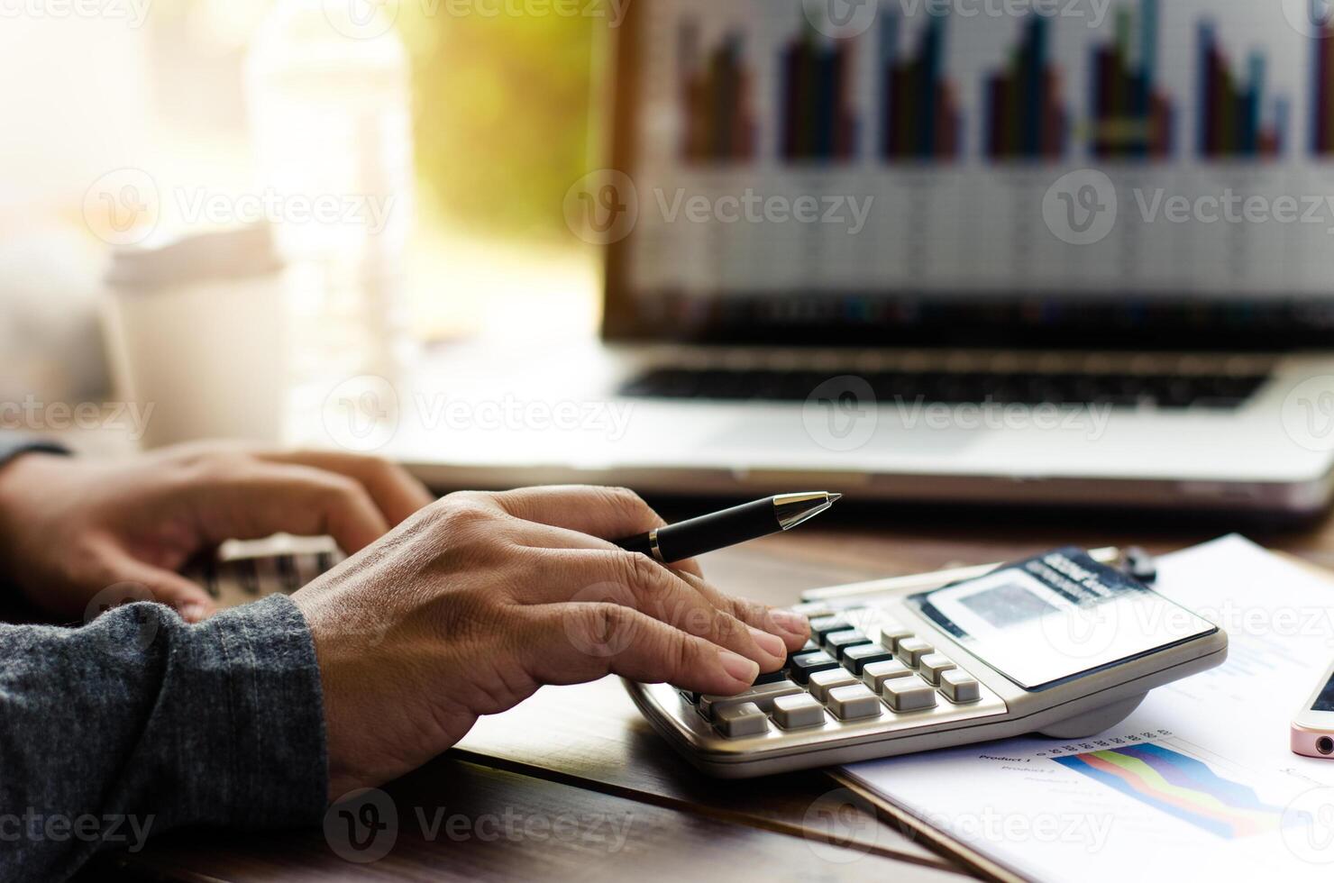 Working on a desk numerical analysis, financial accounting. Graphing Calculator on laptop photo