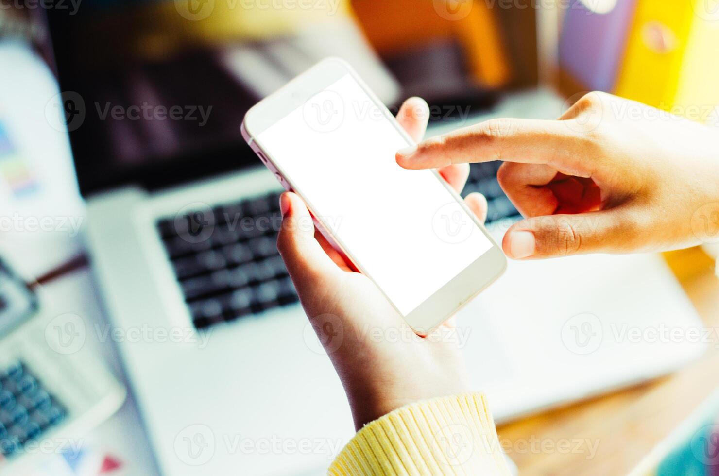 business woman hand working on smart phone with job . working with laptop in open space office. Meeting report in progress. sun glare effect photo