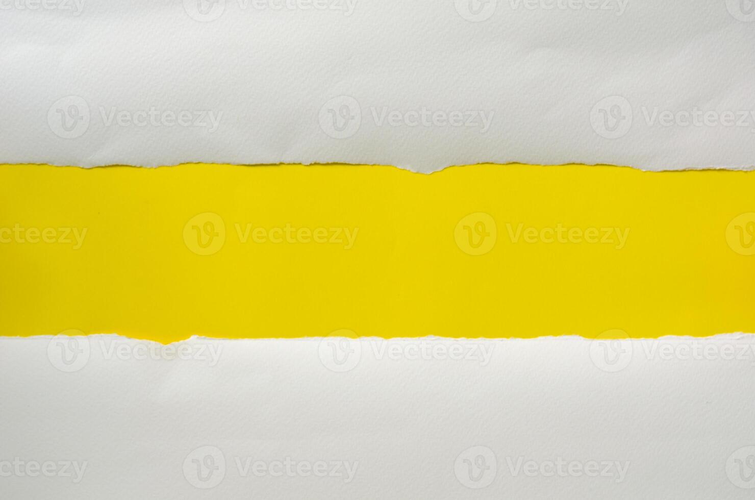 The paper is torn on a yellow background and there is a cutoff to the free space for your text. photo