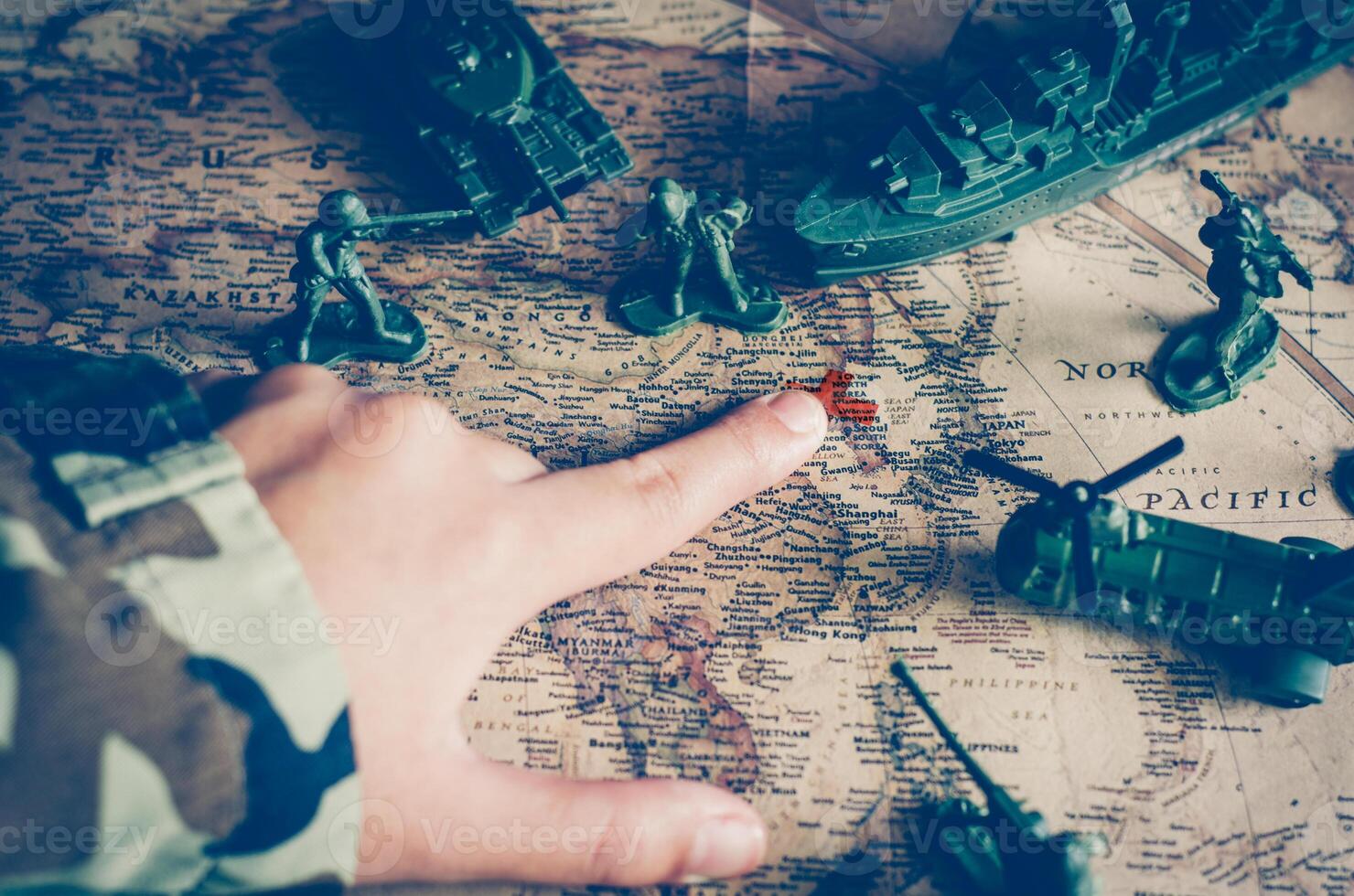 Blurred images of soldiers and tactical battle troops. But focus on world map goals. photo