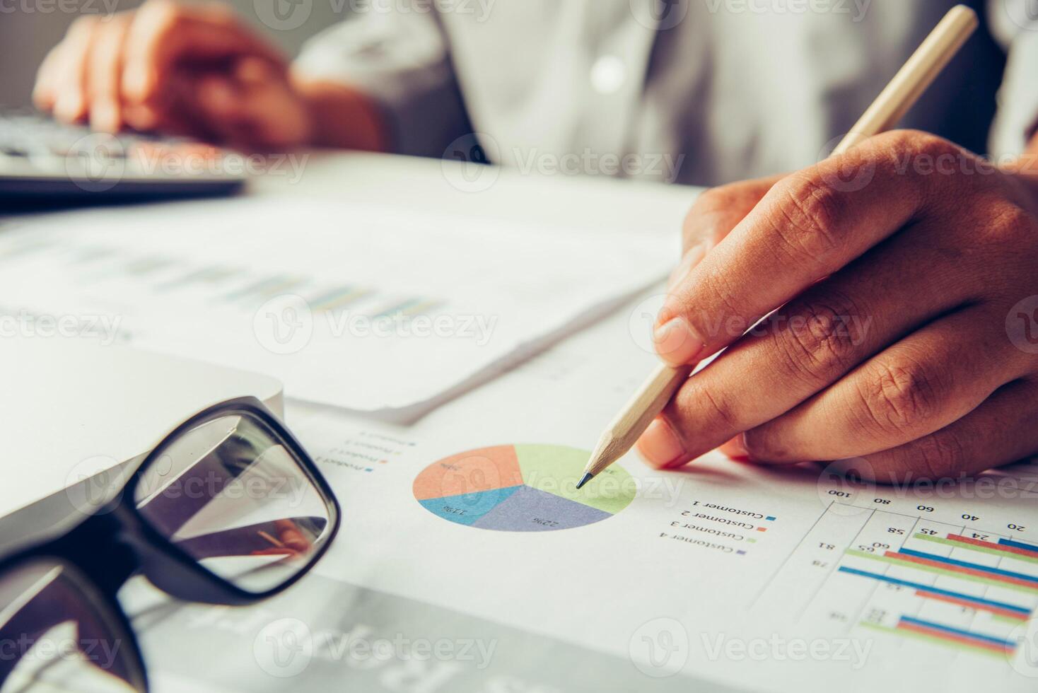 Business people are working on accounts in business analysis with graphs and documentation. photo