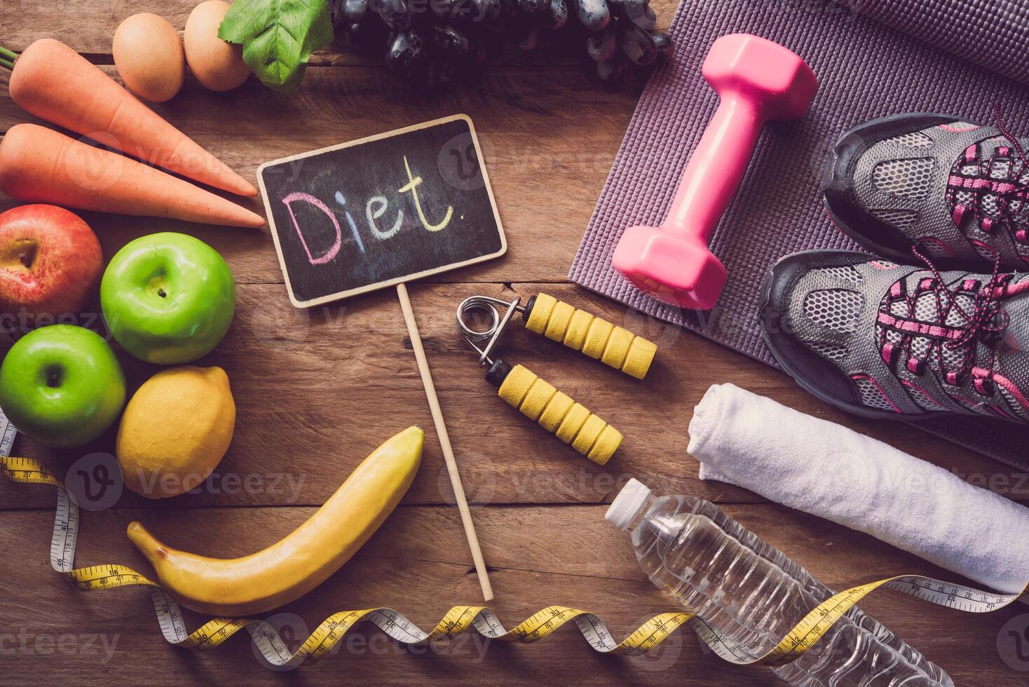 The concept of diet for weight loss  Exercise Equipment and word  diet  in wooden place photo