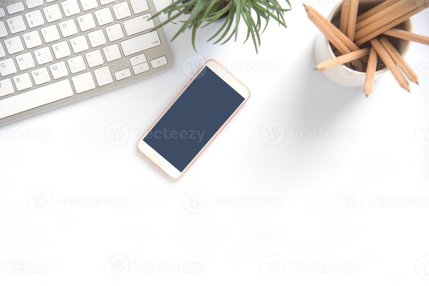 Top view with copy space, working desk with laptop,cell phone,notebook pencil and coffee on white background photo