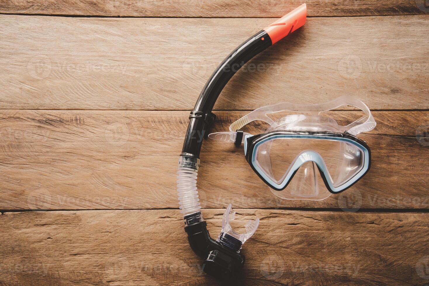 Diving Mask and Snorkel on wooden floor photo