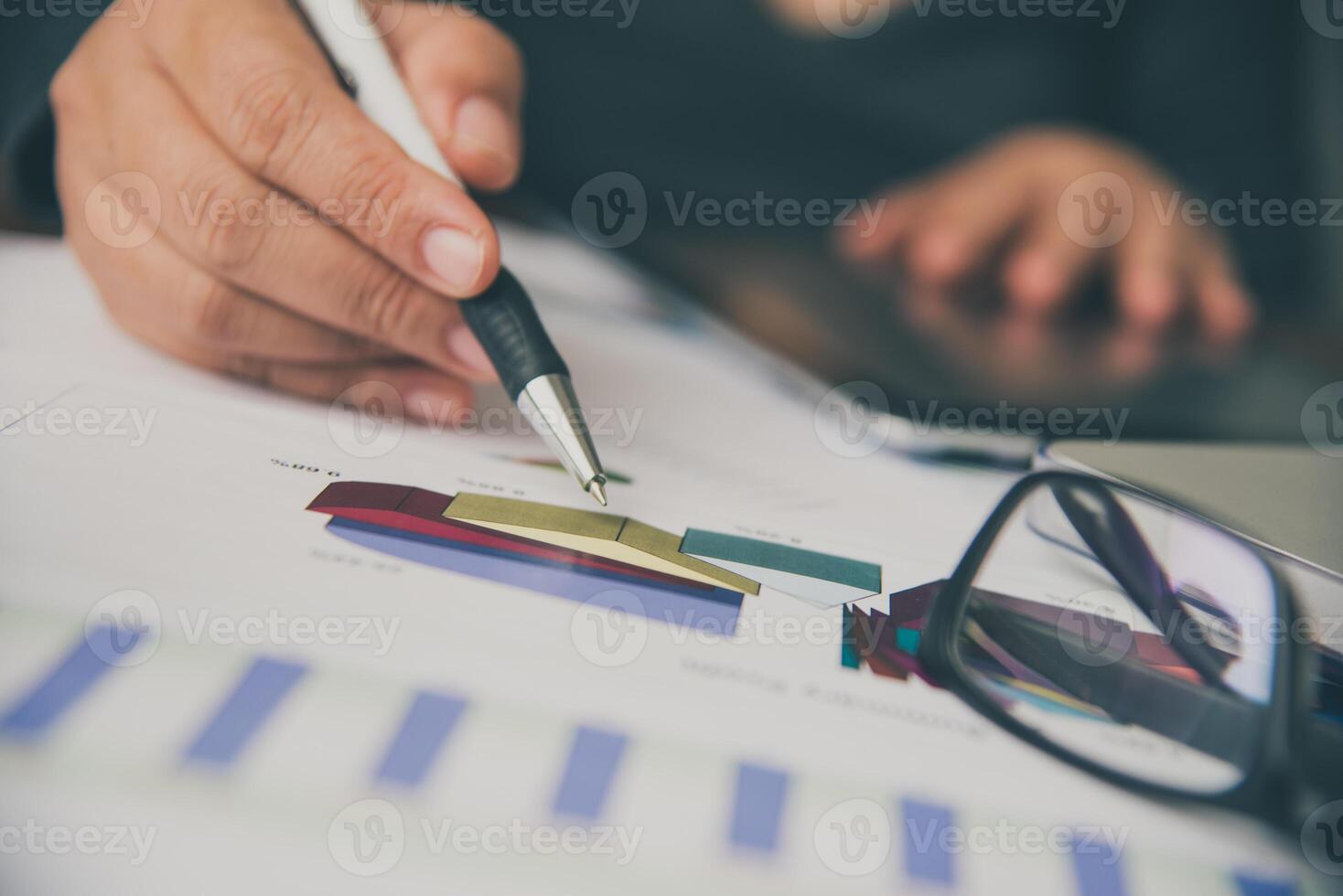 Business people are working on accounts in business analysis with graphs and documentation. photo