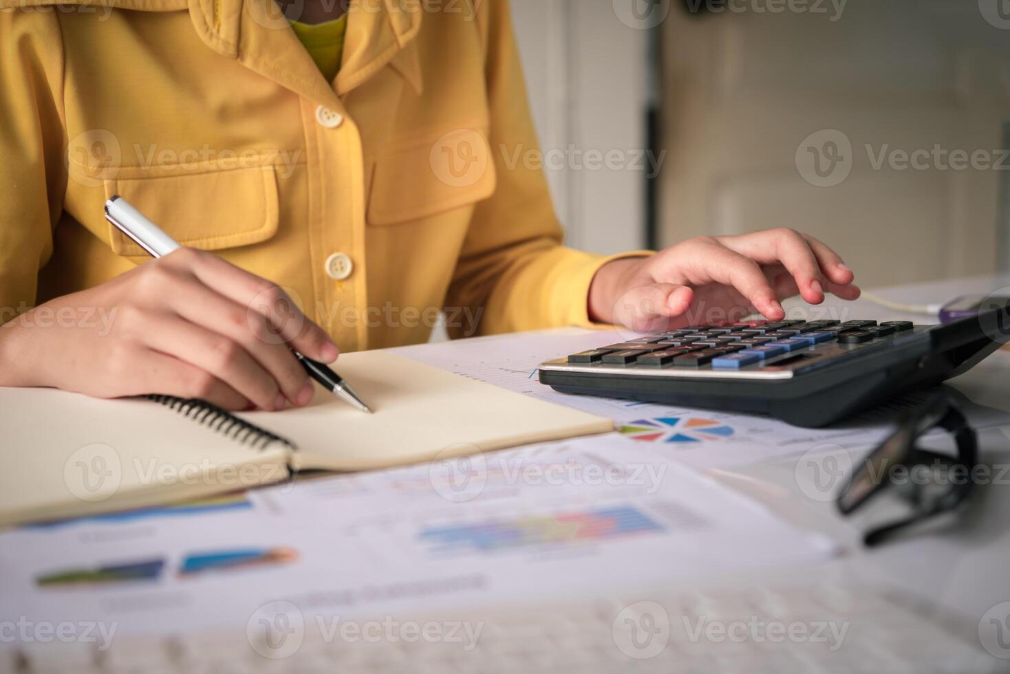Businesswoman a working on accounts in business analysis with graphs and documentation. photo