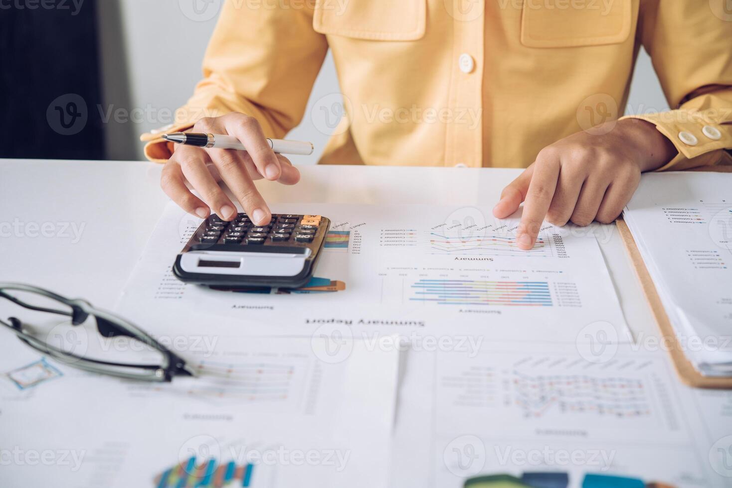 Businesswoman a working on accounts in business analysis with graphs and documentation. photo
