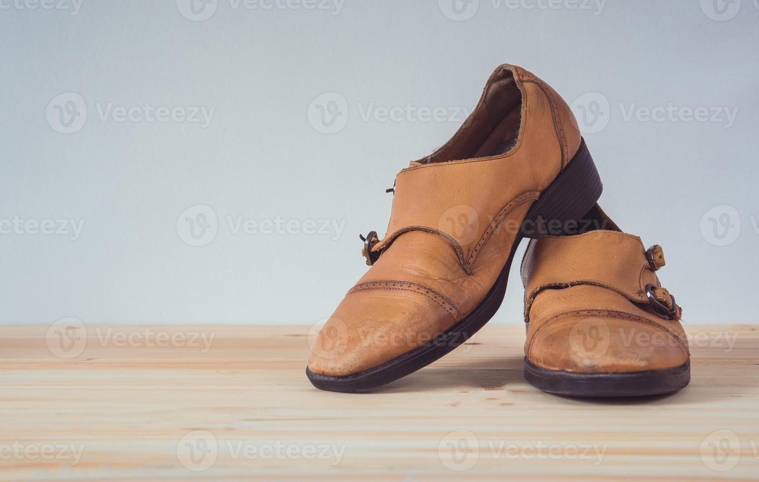 Brown leather boots on wooden floor photo