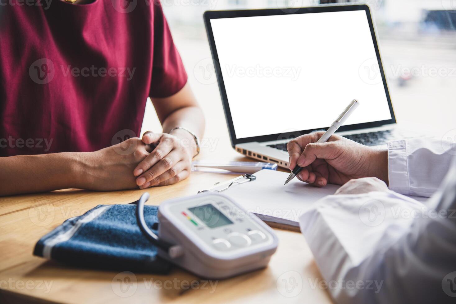 The doctor is discussing with the patient after a physical examination of the results and treatment guidelines. photo