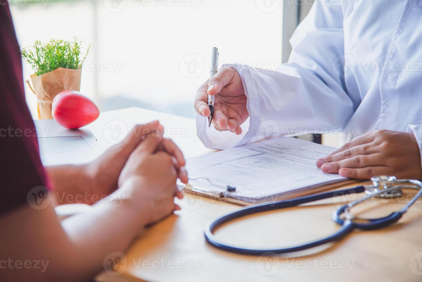 The doctor is discussing with the patient after a physical examination of the results and treatment guidelines. photo