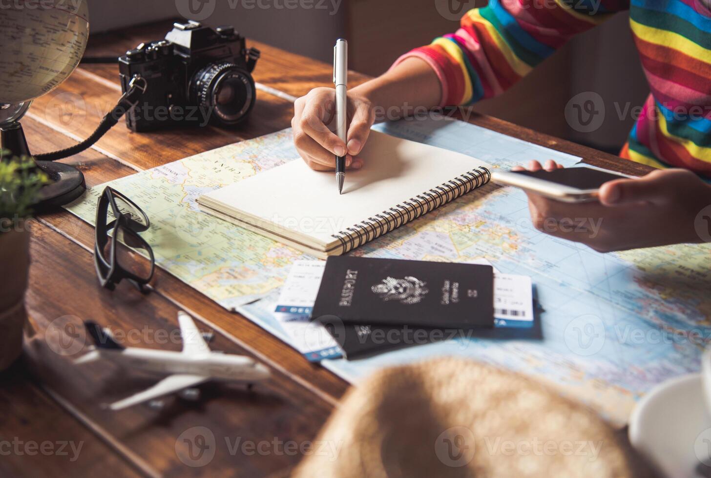 Travelers are planning a trip by searching the route on the map and searching for information on the internet. photo