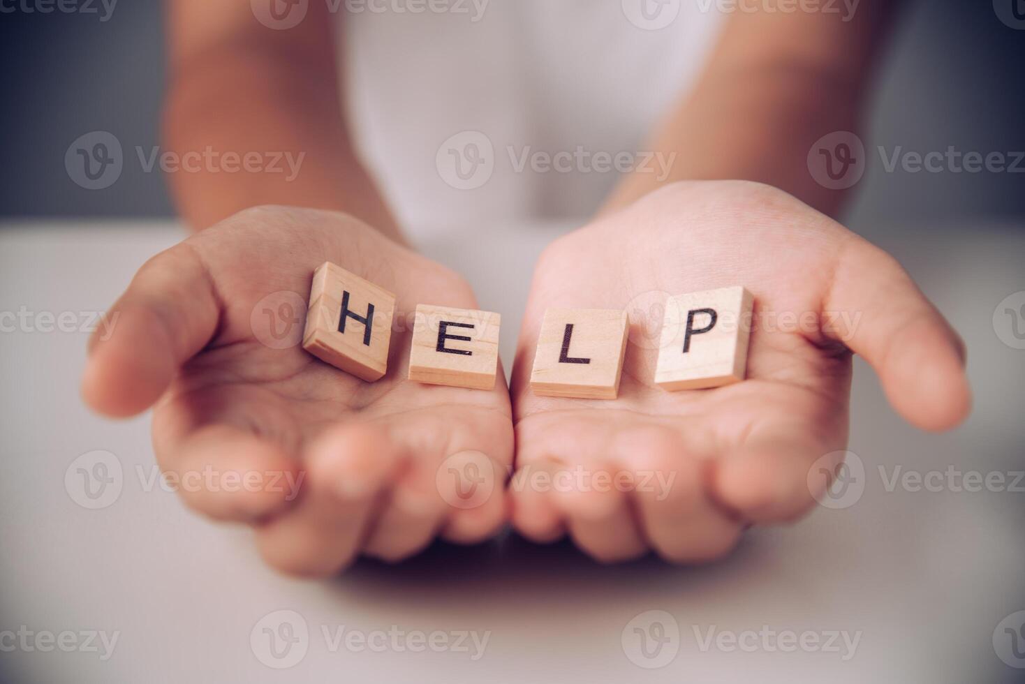 The word HELP in hands in cupped shape. photo