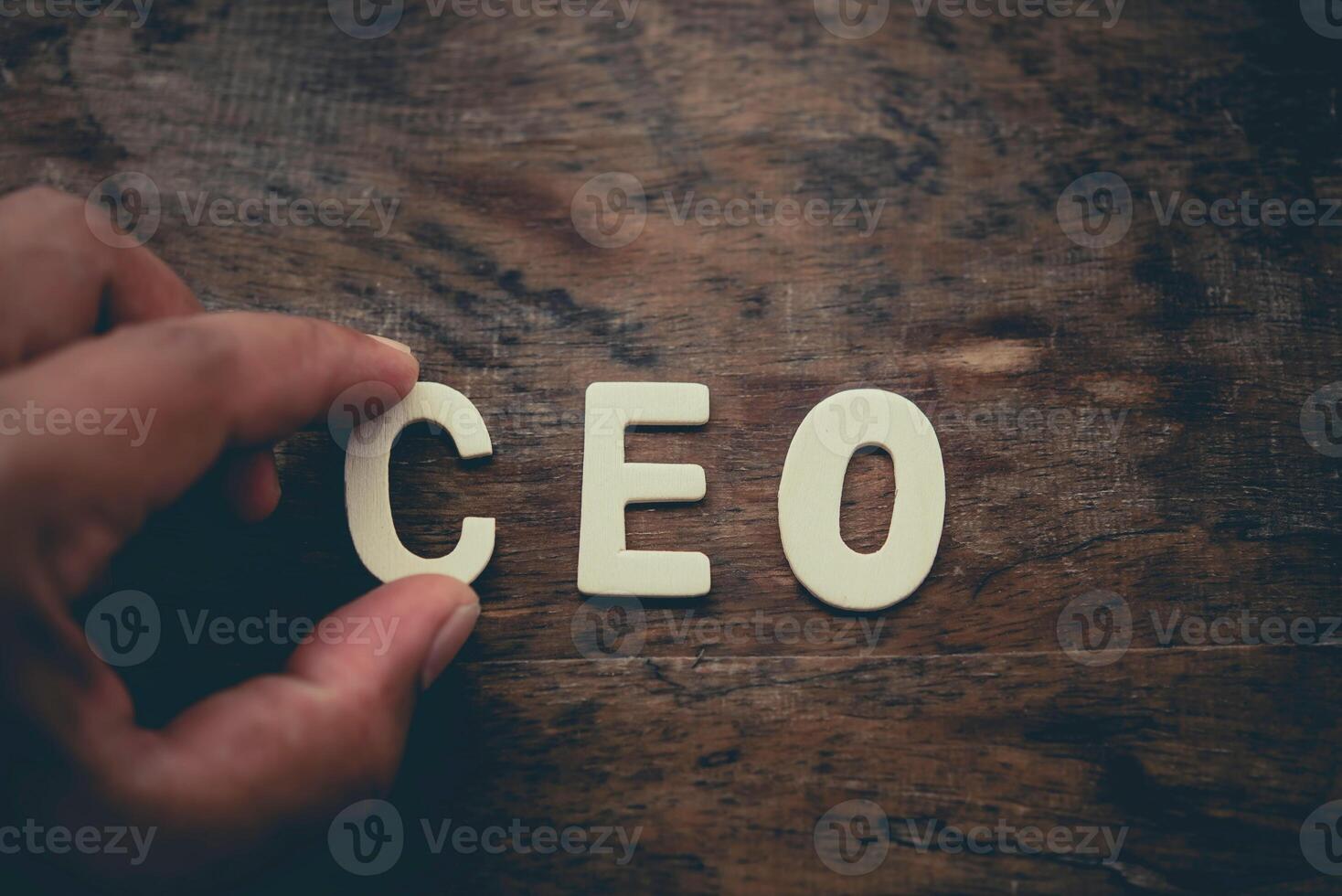 Place the word CEO white on the wooden floor. photo