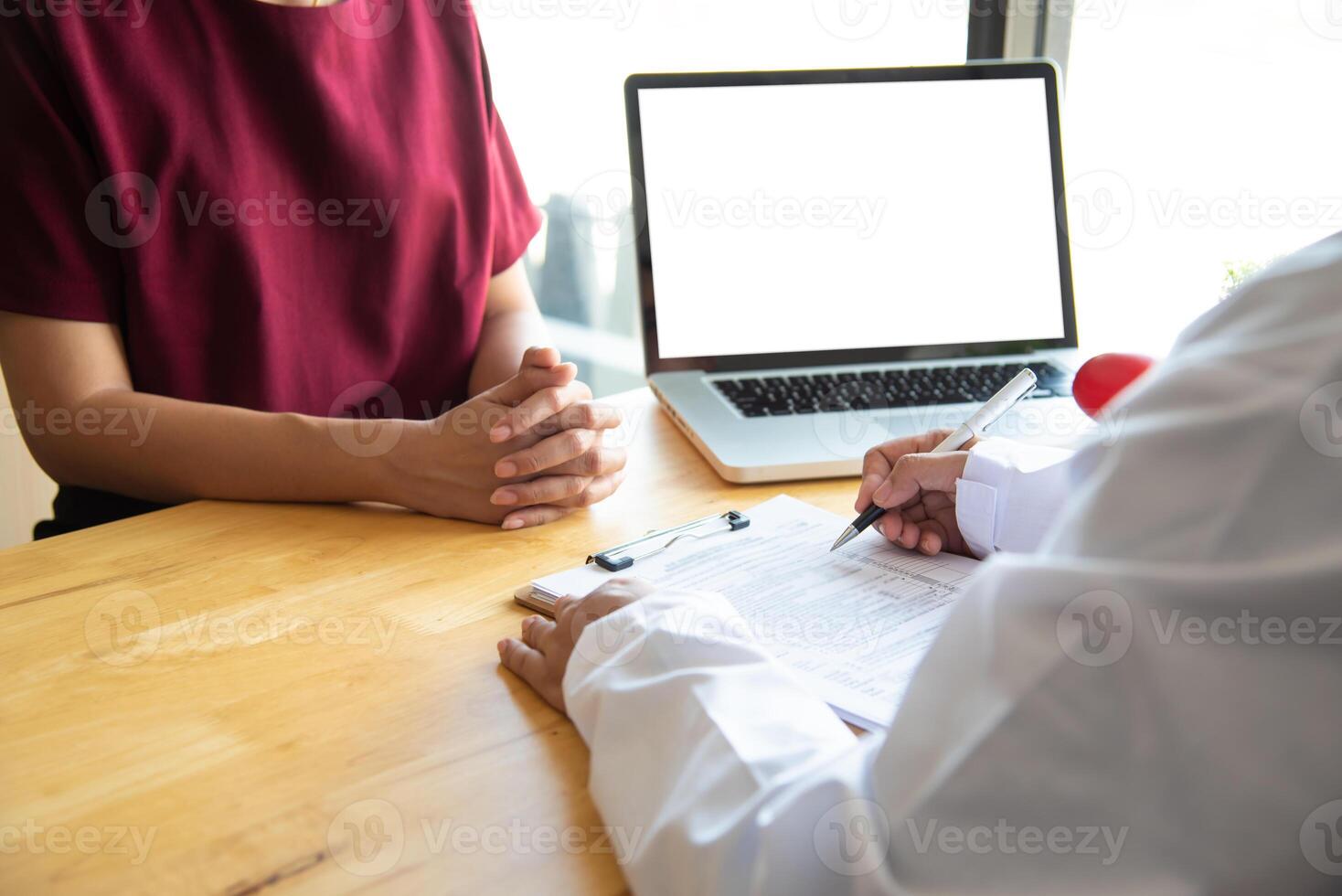 The doctor is discussing with the patient after a physical examination of the results and treatment guidelines. photo