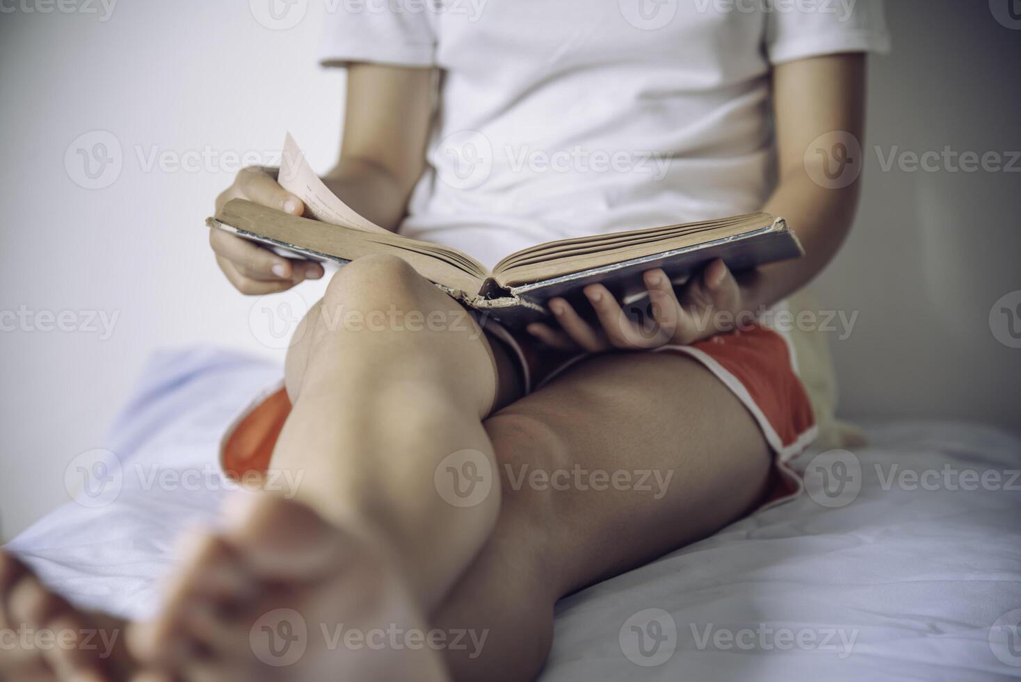 Teens read books on the bed in the bedroom. photo