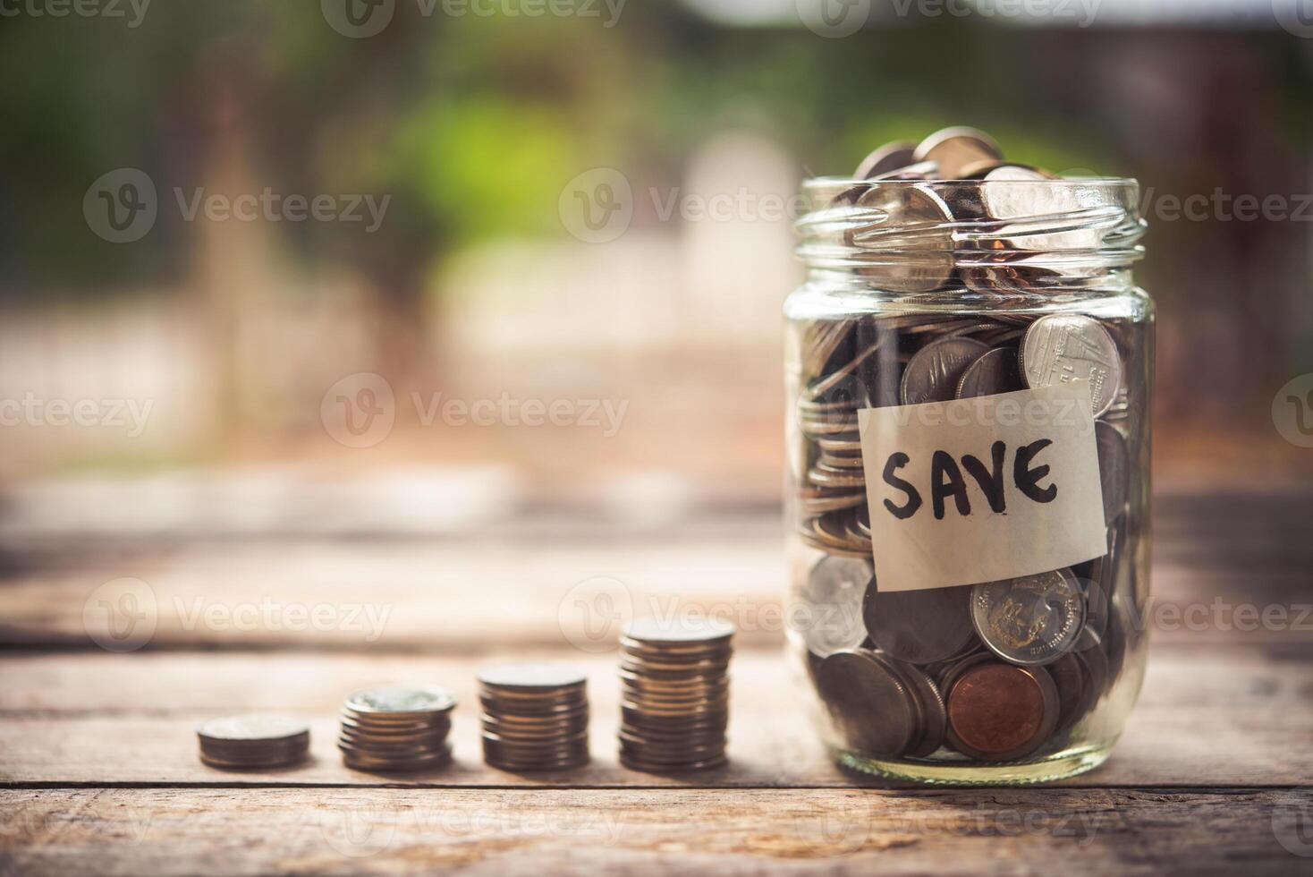 Coins in glass jar for money saving Investment and finance concept photo