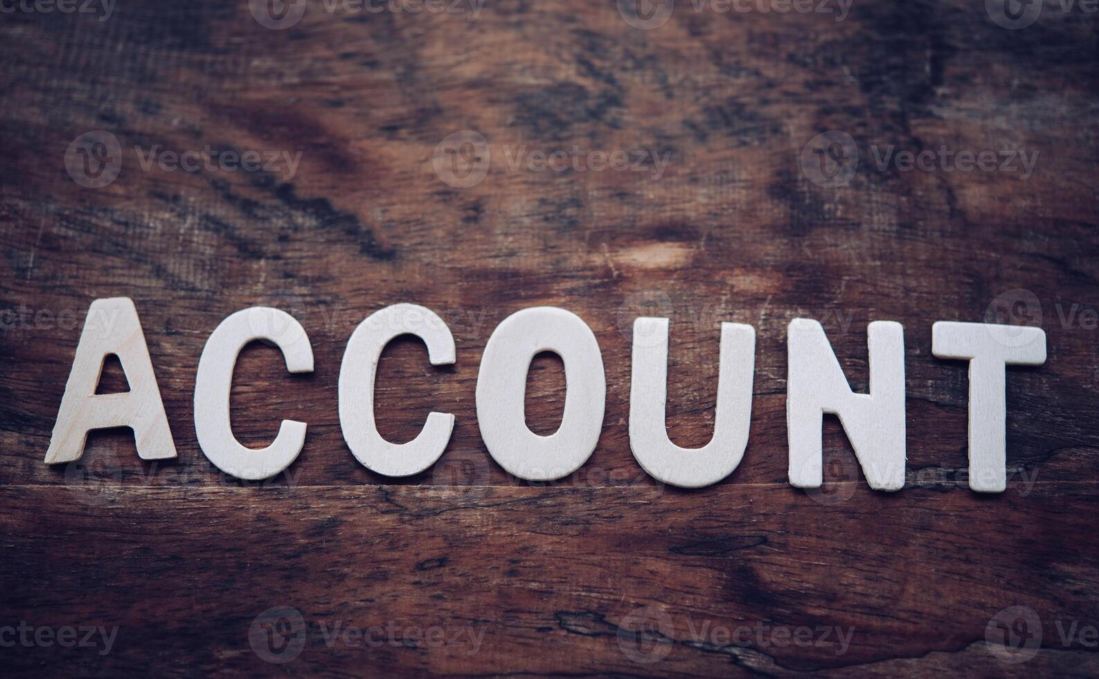 Place the word  ACCOUNT white on the wooden floor. photo