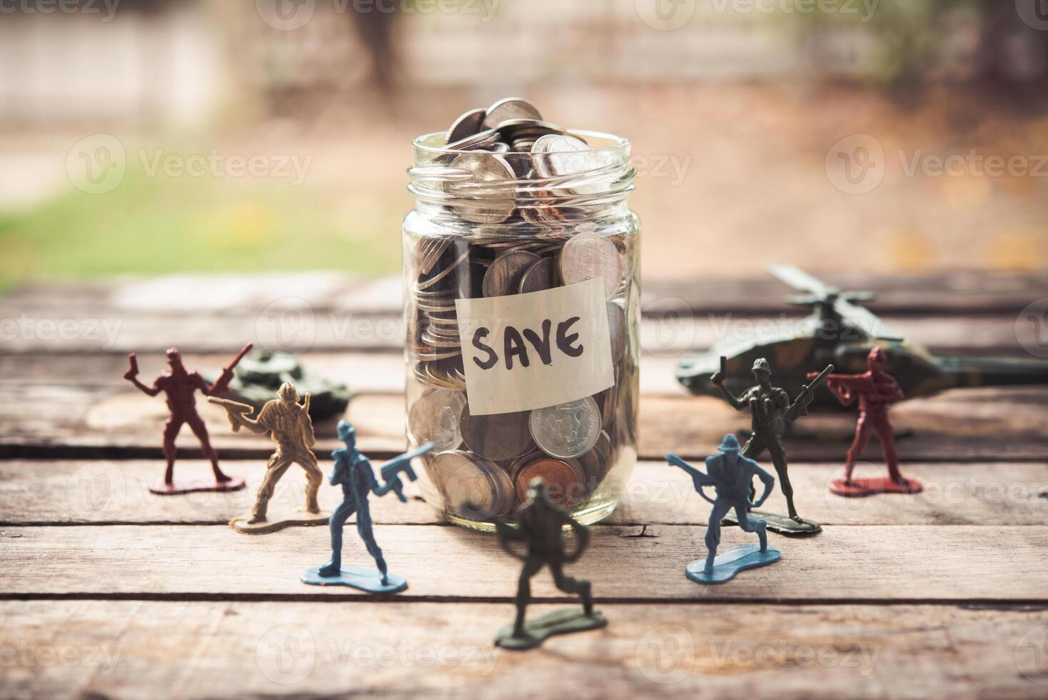 Toy Soldier Dolls are placed around a dozen glasses with coins inside - a concept protecting the business. photo