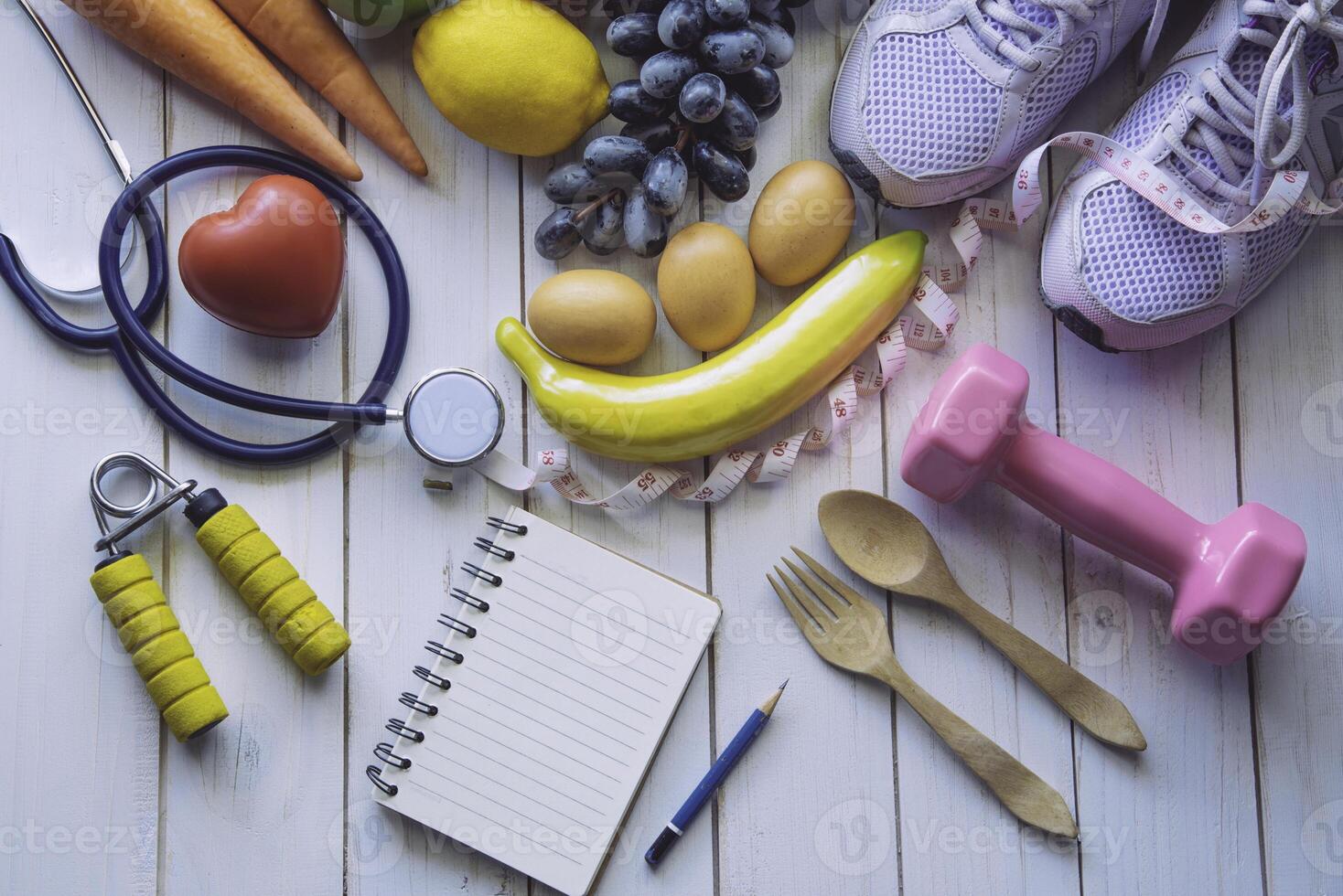 fitness concept with Exercise Equipment on white wooden background. photo