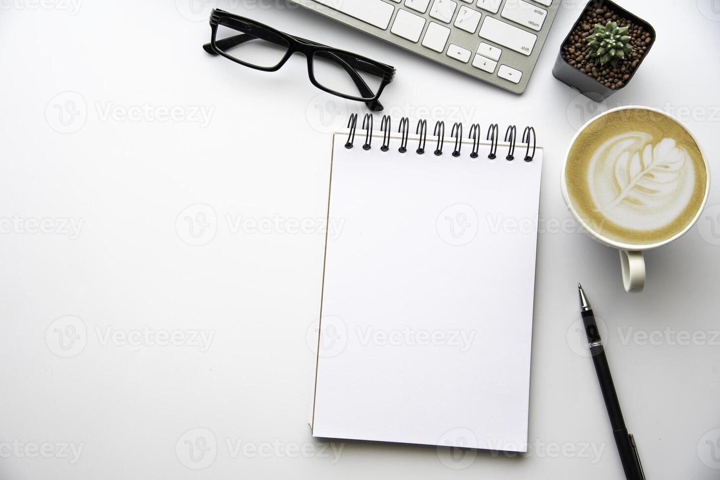 Top view with copy space, working desk with laptop,cell phone,notebook pencil and coffee on white background photo