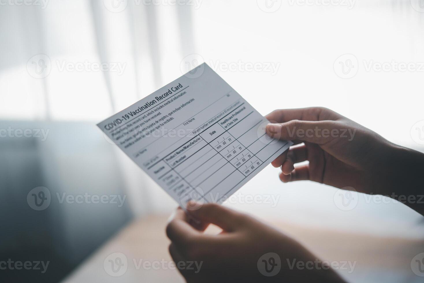 Coronavirus vaccination record card is held in hand. patient who has already been vaccinated with Coronavirus .Coronavirus prevention photo