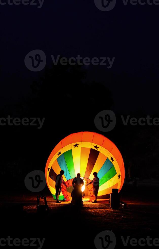 The team is preparing a balloon with a fire to make the balloon rise. photo