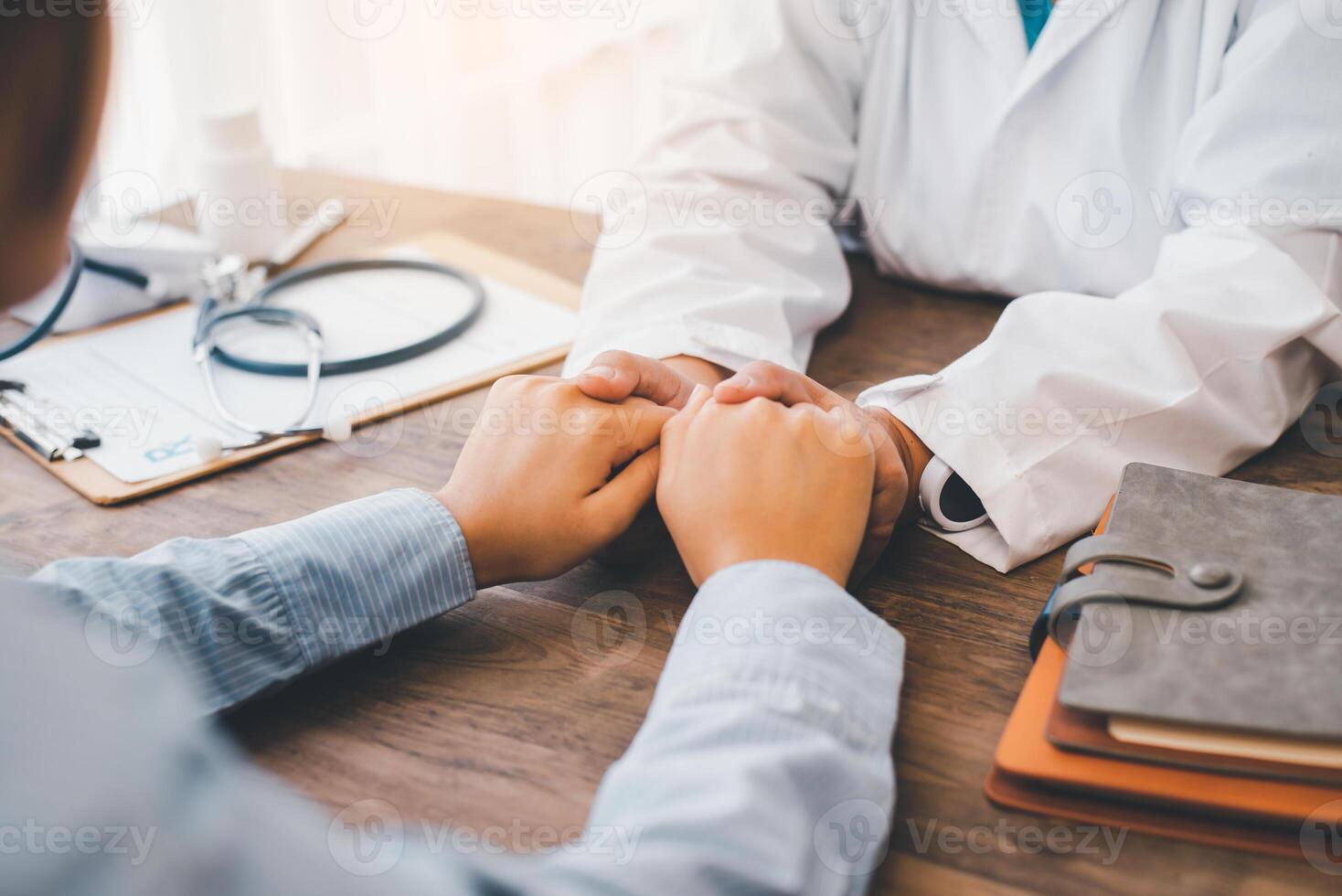 Close-up of the psychiatrist's hand holding the patient's hand. To encourage and comfort the patient photo