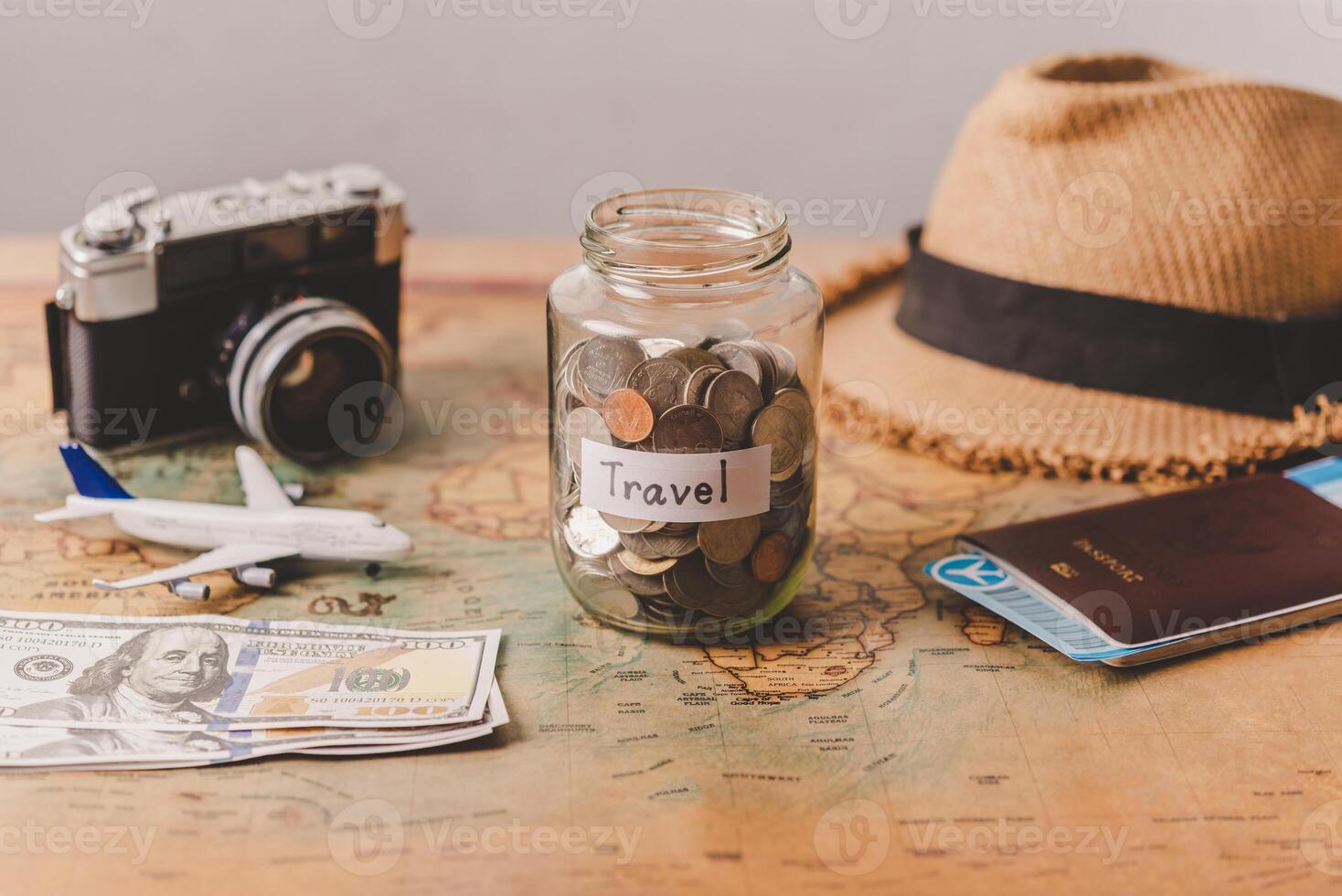 The money in the jar stored on the map, along with a passport, concept to collect money for travel. photo