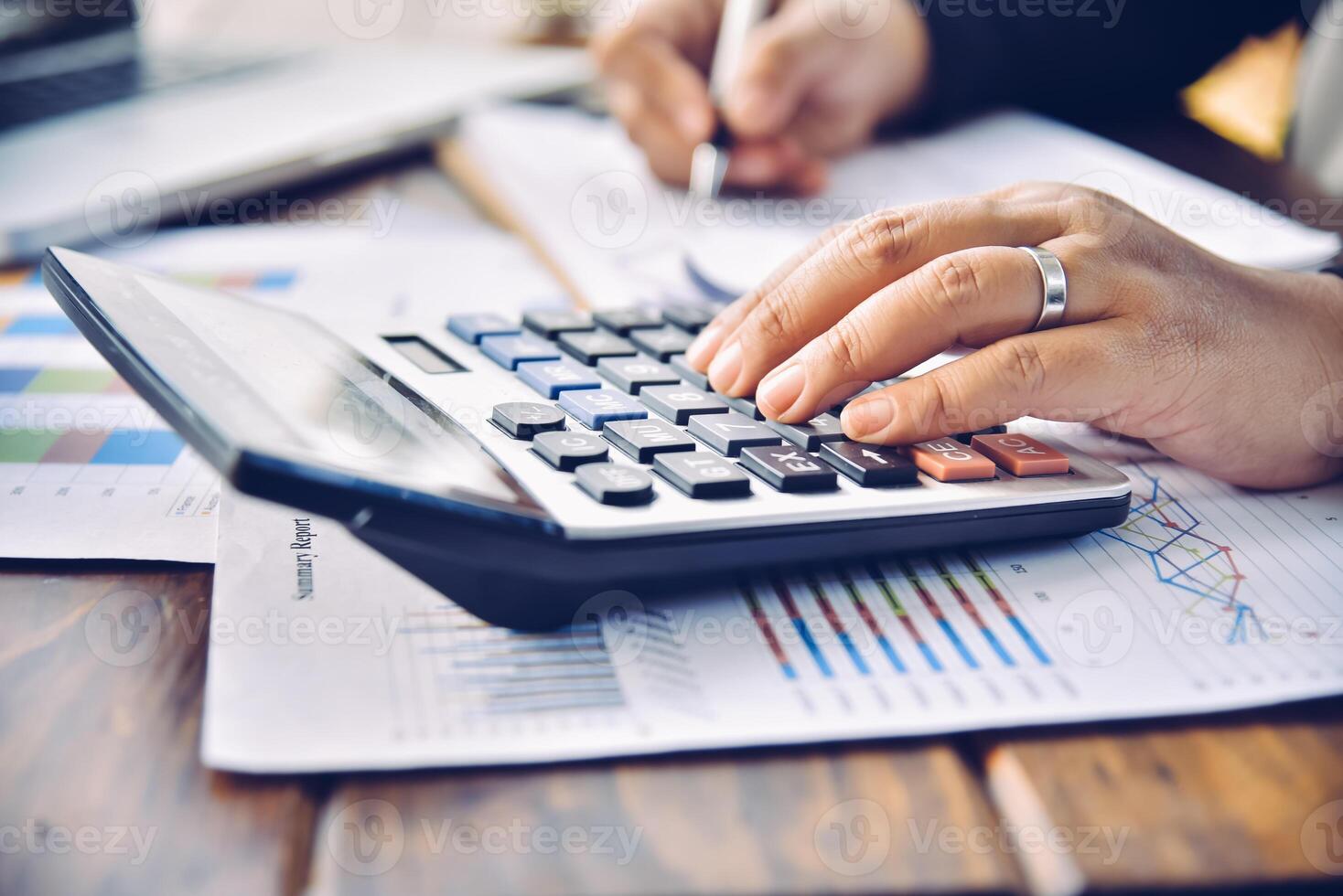 Businessman are working with a calculator and document. Meeting report in progress. in office business concept photo