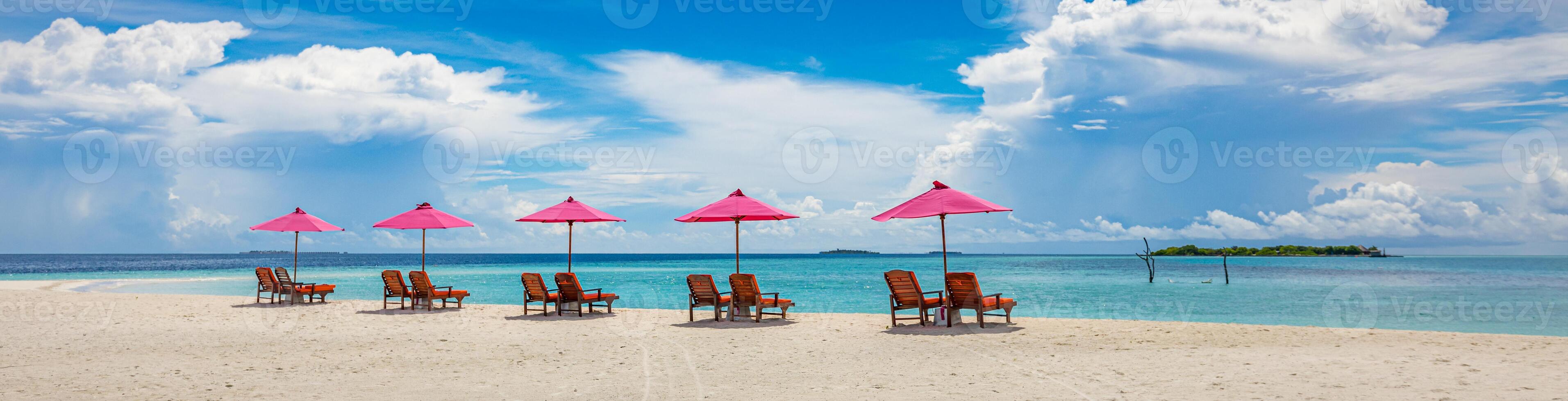 Beautiful tropical beach scenery. sun beds, loungers, umbrella under palm tree. White sand, sea view with horizon, colorful sunshine sky, calmness and relaxation. Inspirational beach resort hotel photo