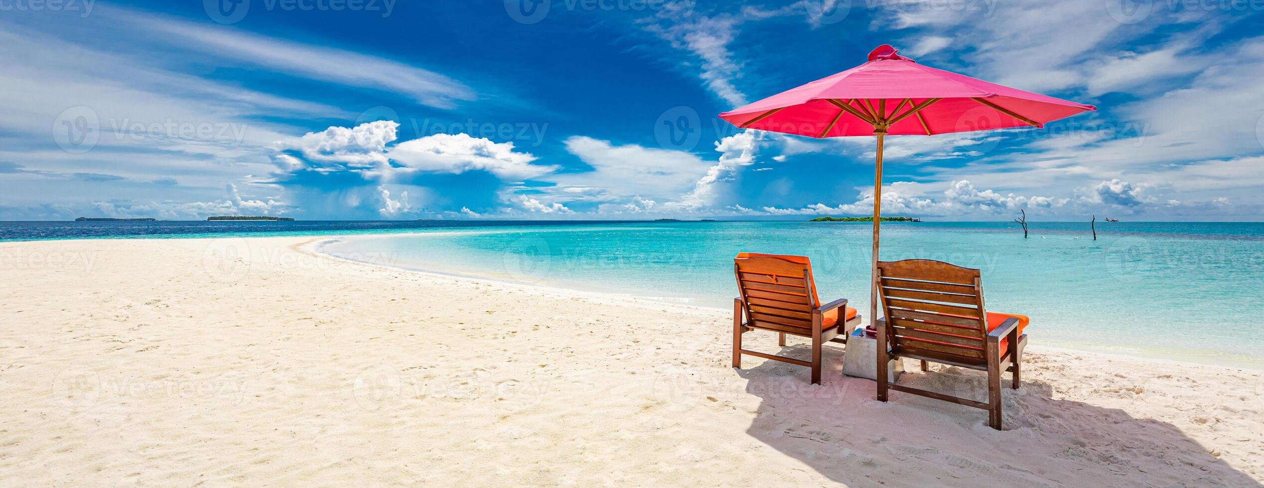 Beautiful tropical beach scenery. sun beds, loungers, umbrella under palm tree. White sand, sea view with horizon, colorful sunshine sky, calmness and relaxation. Inspirational beach resort hotel photo