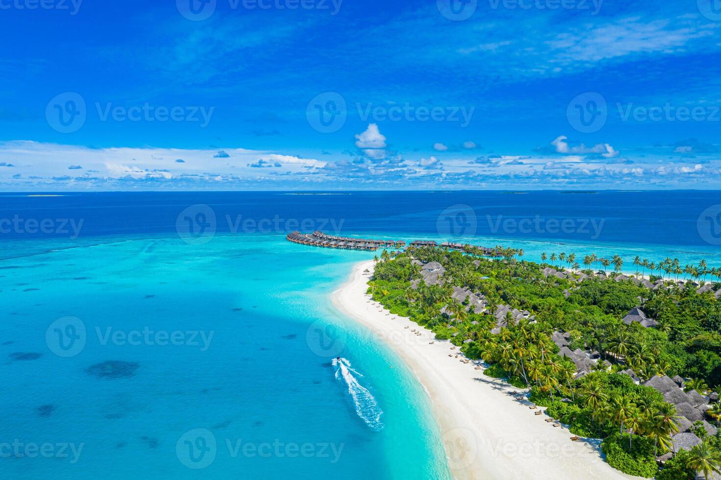 Stunning aerial landscape, luxury tropical resort with water villas. Beautiful island beach, palm trees, sunny sky. Amazing bird eyes view in Maldives, paradise coast. Exotic tourism, relax nature sea photo