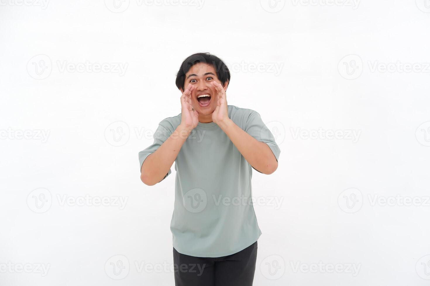 A young Asian man employee wearing tshirt is shouting and screaming loud with a hand on her mouth, isolated by white background. photo
