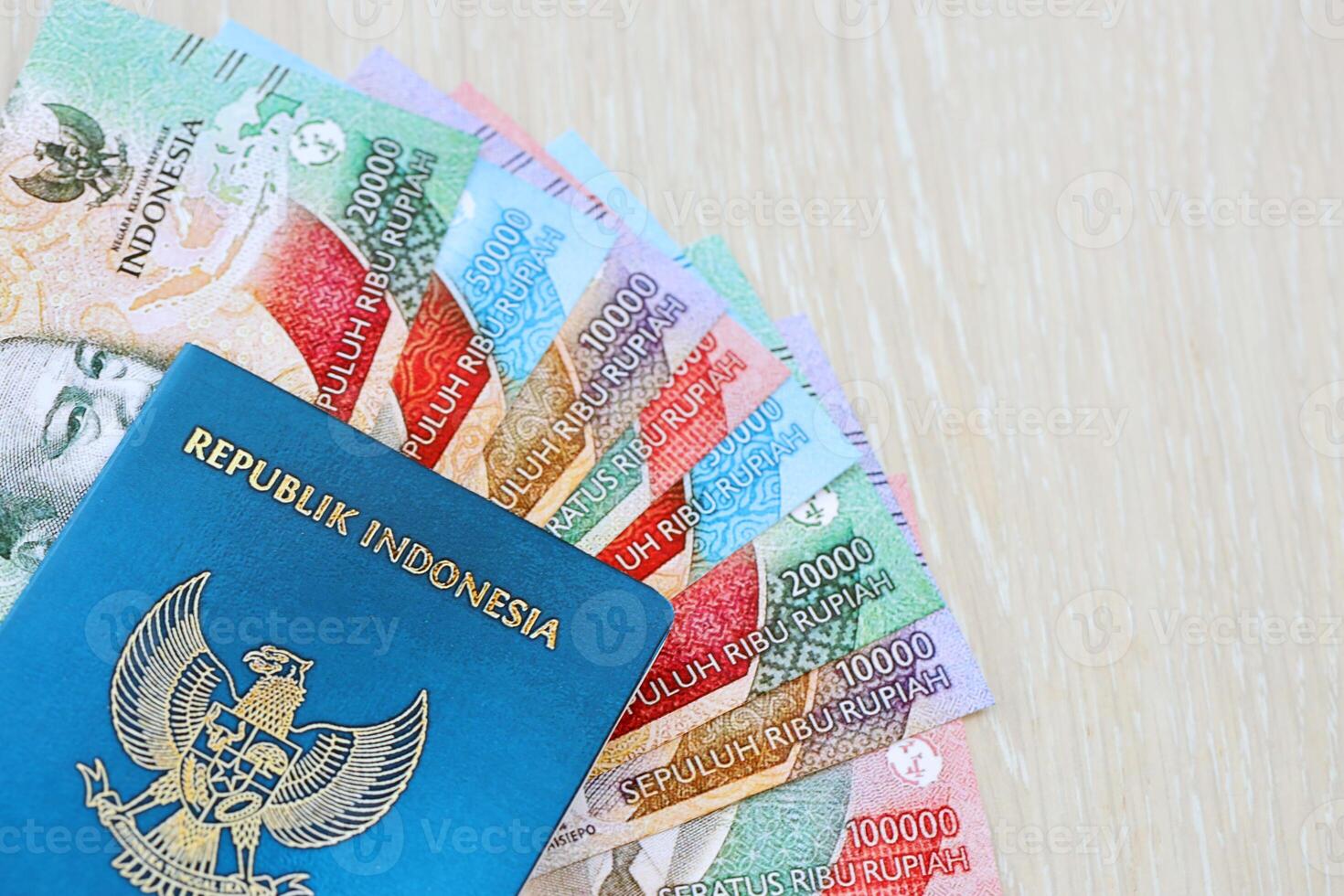 Indonesia passport and many indonesian rupiah currency money bills photo