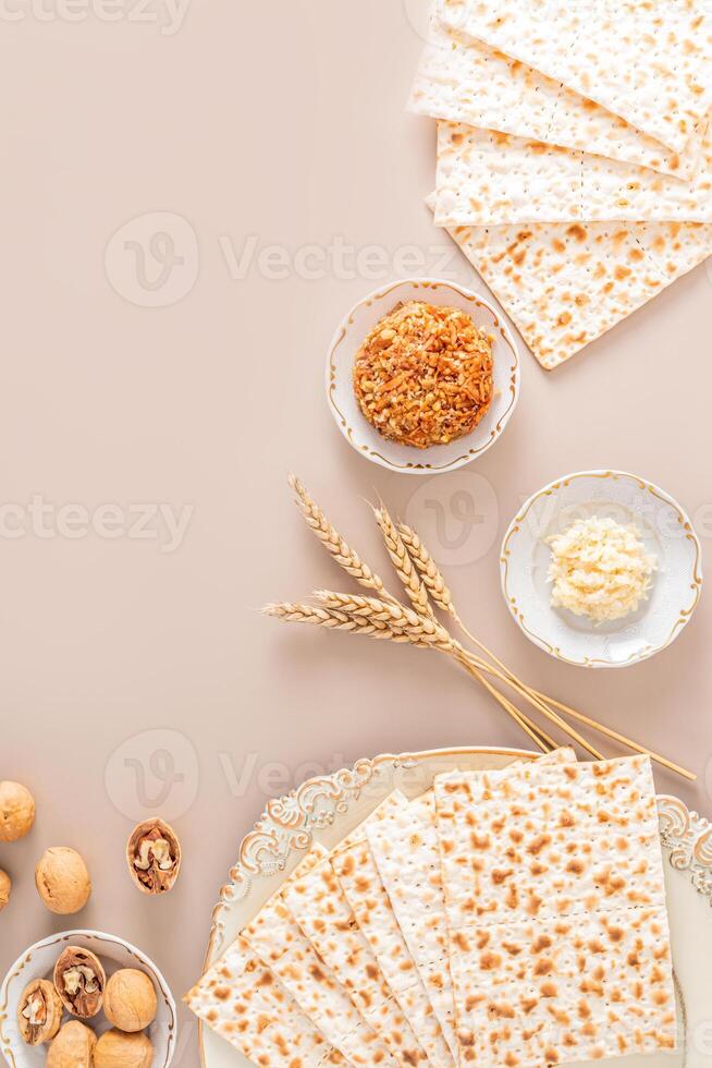 Festive vertical background for Jewish Passover holiday with traditional food and symbols. The concept of the Passover holiday. A copy space. Flat lay photo