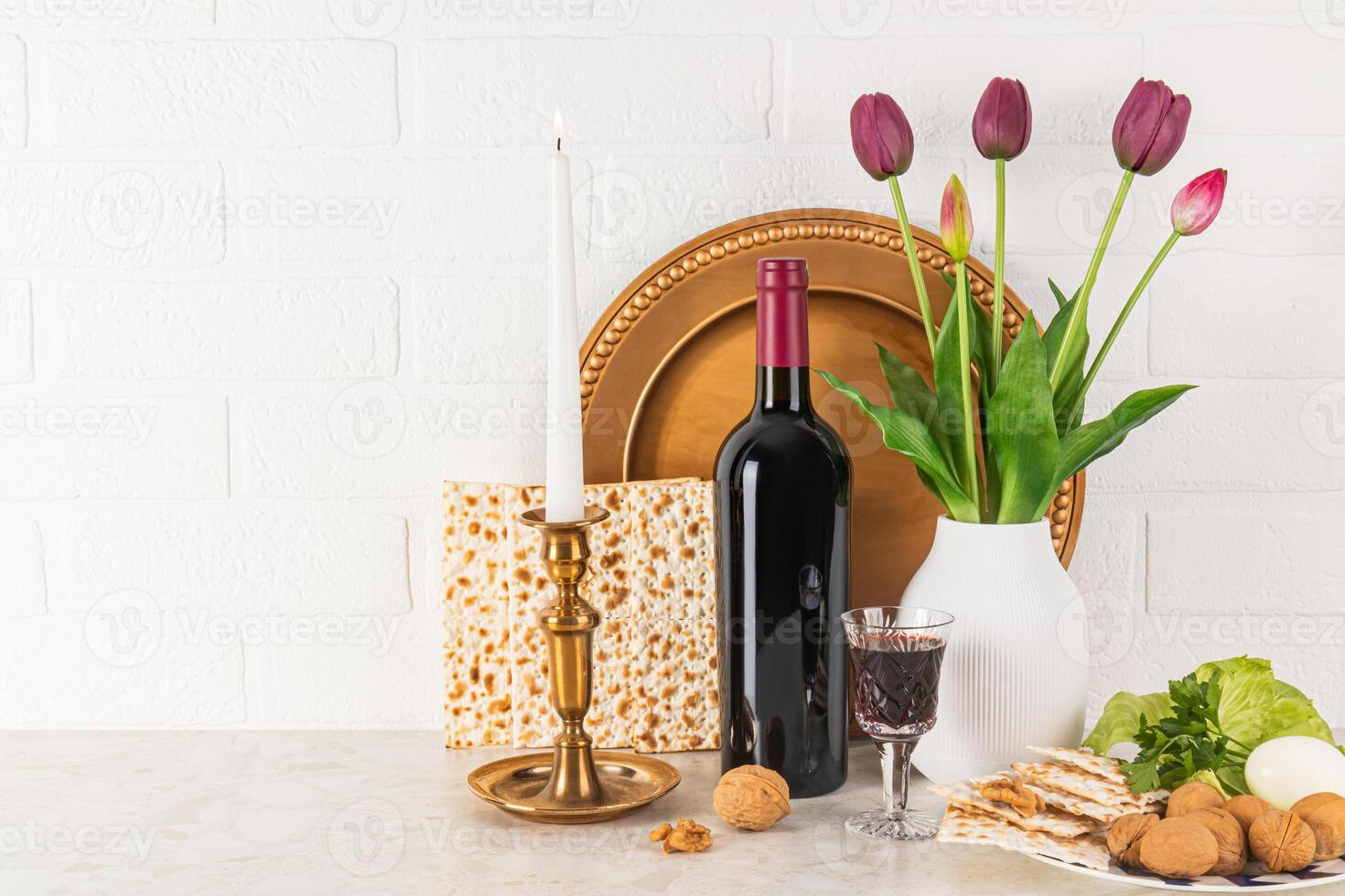 Beautiful still life for the spring holiday of Jewish Passover. Front view of traditional products for holiday, matzoth, bottle of red wine, dish. photo