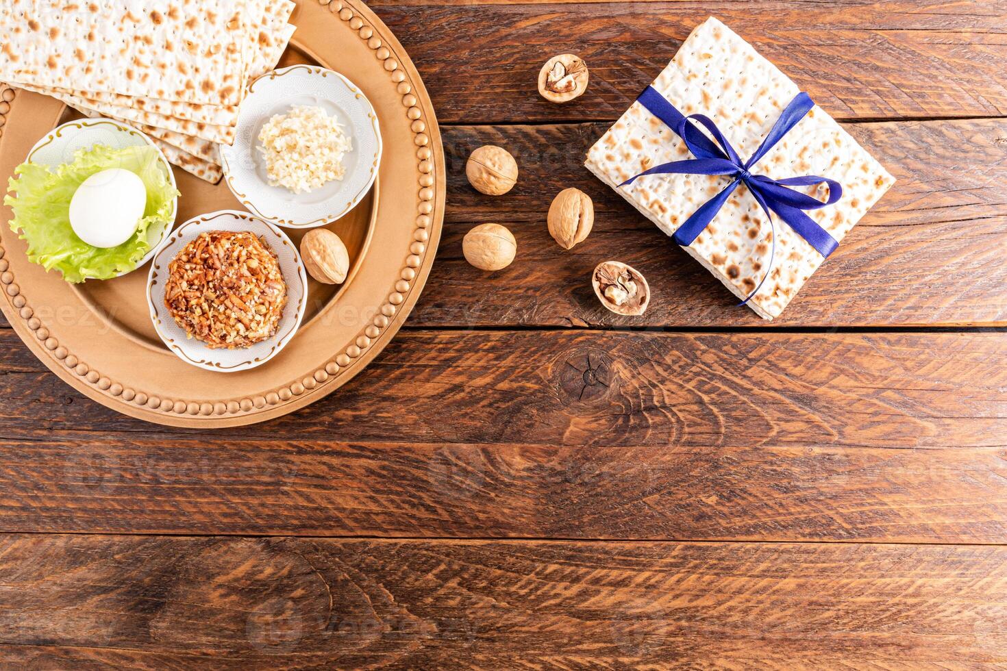 Top view of traditional treats for the Jewish holiday of Passover on a wooden rustic table. A copy space. Passover holiday concept. photo