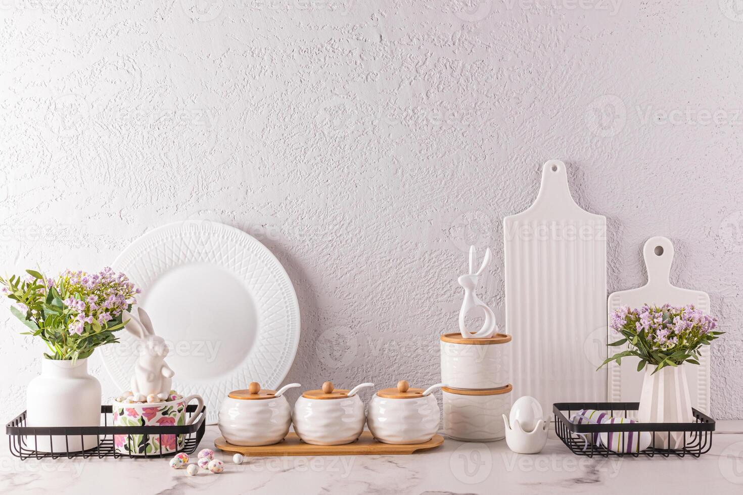 Stylish kitchen background for Easter holiday with traditional symbols and white tableware. foreground. Easter holiday concept. photo
