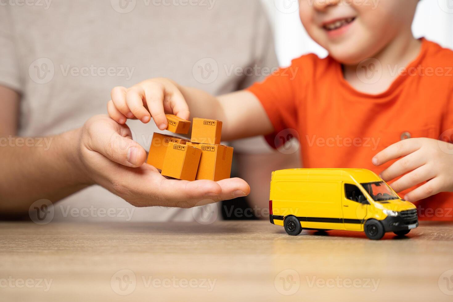 Father and son play order delivery game. A man teaches a boy how delivery works. Initiation into the family business. Home moving. Sense of understanding and participation. Importance of teamwork photo