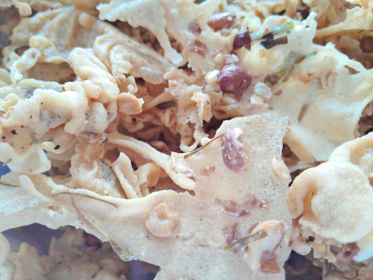 Photo of typical Indonesian food peanut brittle or Peyek, Rempeyek. This photo is perfect for food magazines, tabloid newspapers, food recipe books.