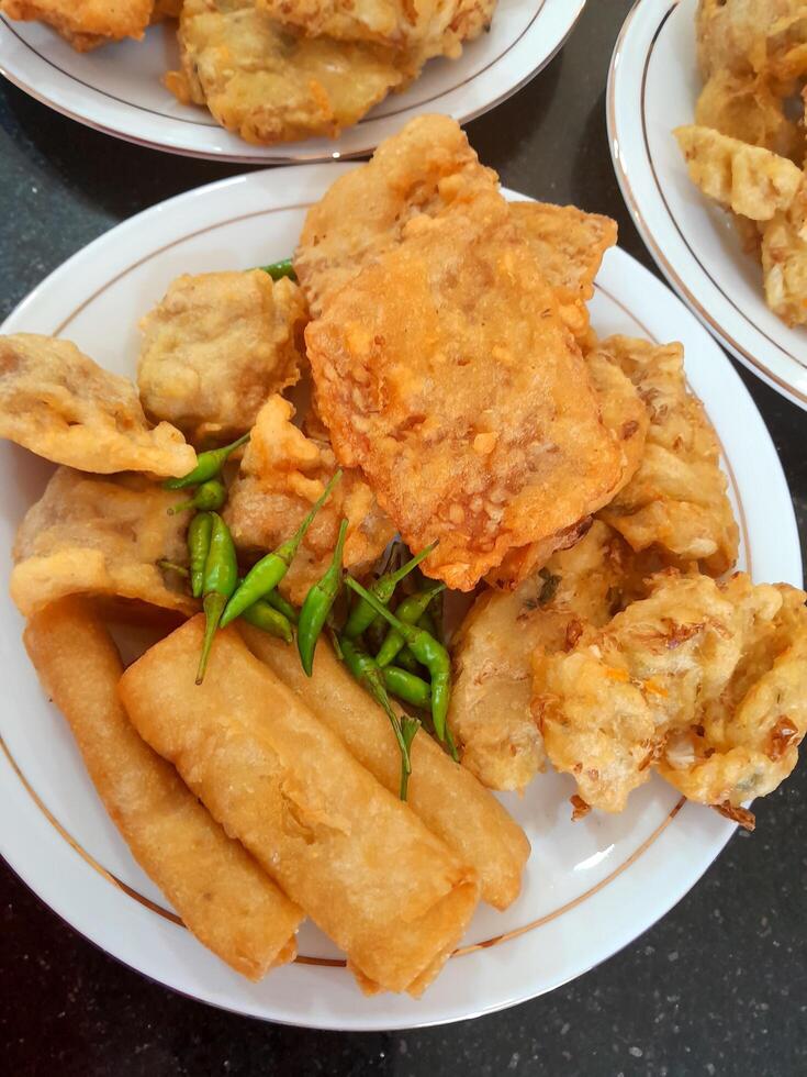 Fried food or Gorengan typical of Indonesia made from wheat, tempeh, vegetables. This photo is perfect for magazines, newspapers, cookbooks, advertisements, banners, posters