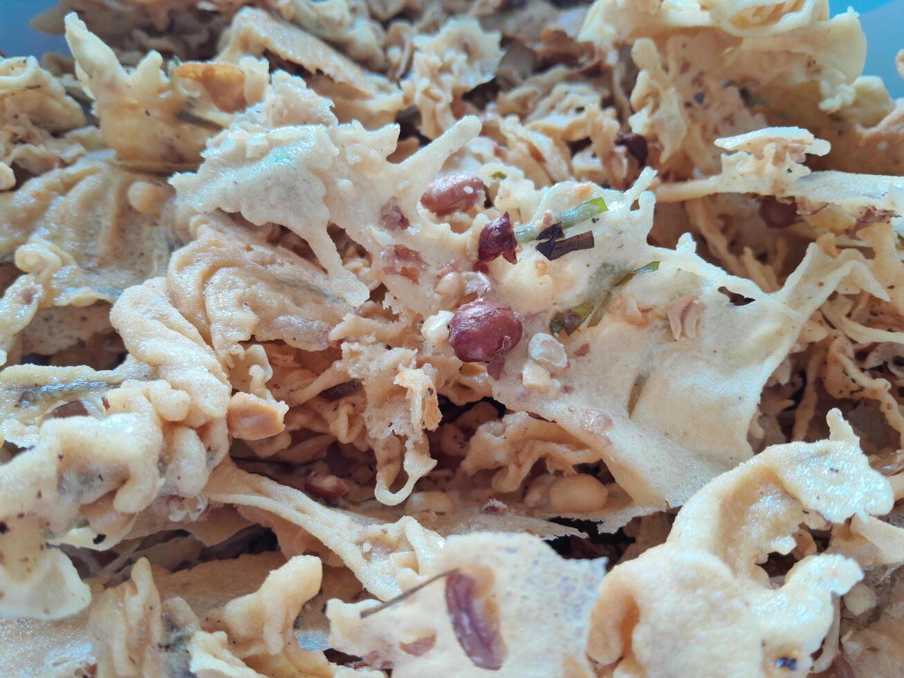 Photo of typical Indonesian food peanut brittle or Peyek, Rempeyek. This photo is perfect for food magazines, tabloid newspapers, food recipe books.