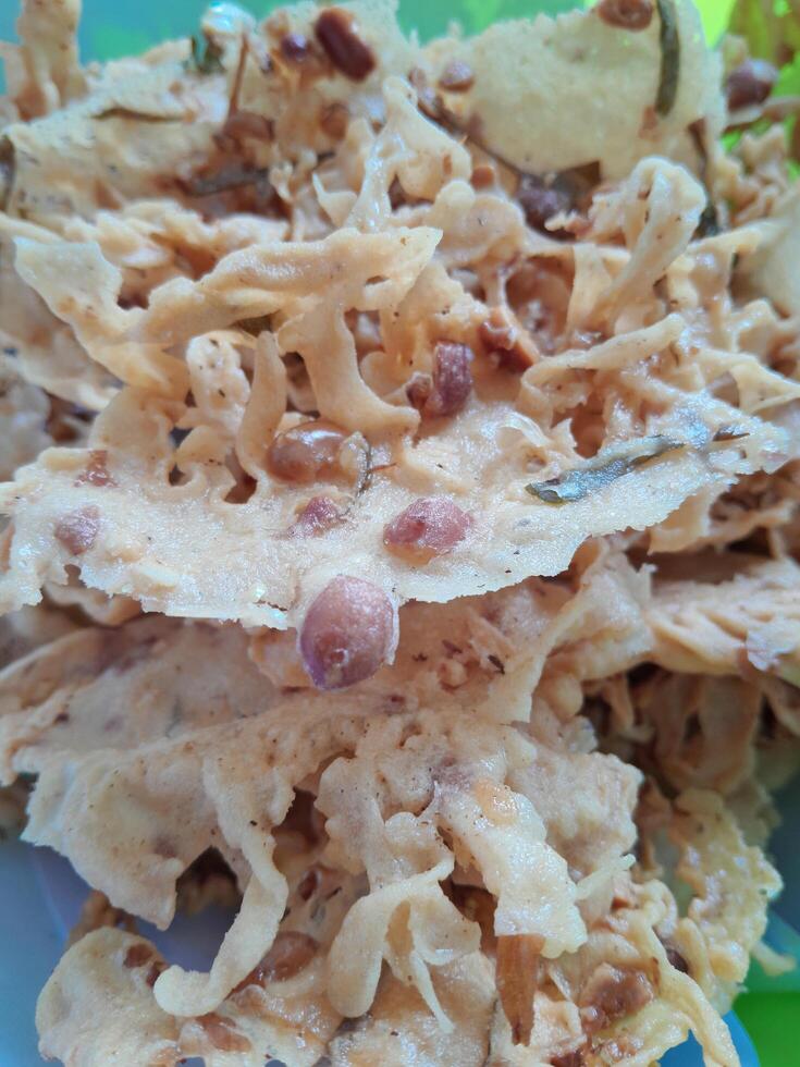 Photo of typical Indonesian food peanut brittle or Peyek, Rempeyek. This photo is perfect for food magazines, tabloid newspapers, food recipe books.