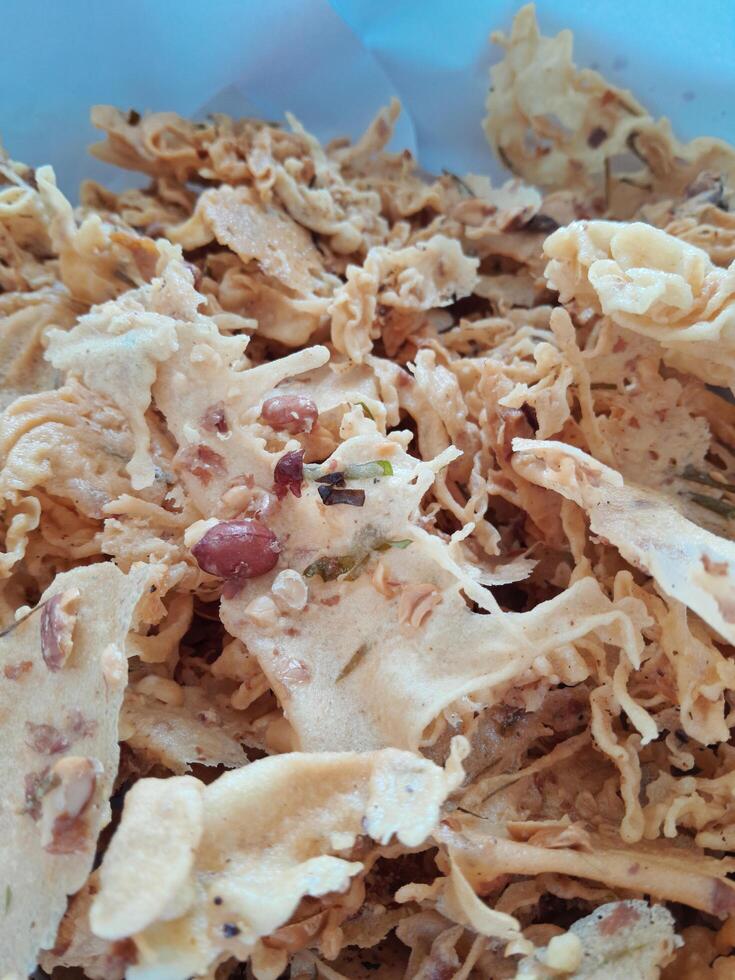 Photo of typical Indonesian food peanut brittle or Peyek, Rempeyek. This photo is perfect for food magazines, tabloid newspapers, food recipe books.