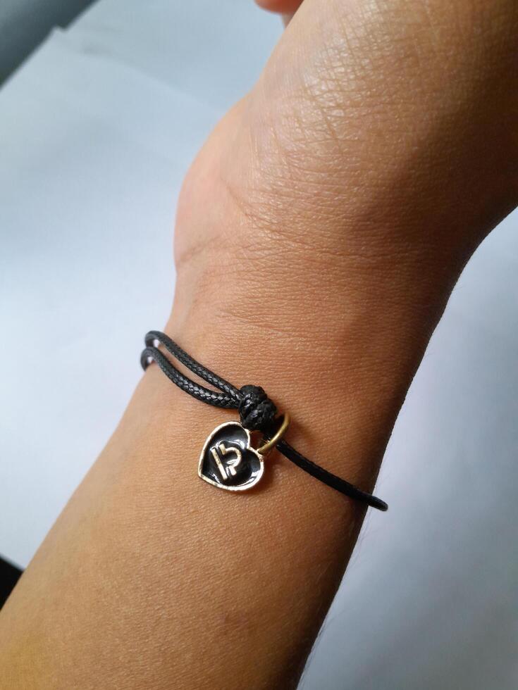 Photo of bracelet with zodiac pendant. This photo is suitable for advertising photos, calendars, magazines, posters, banners