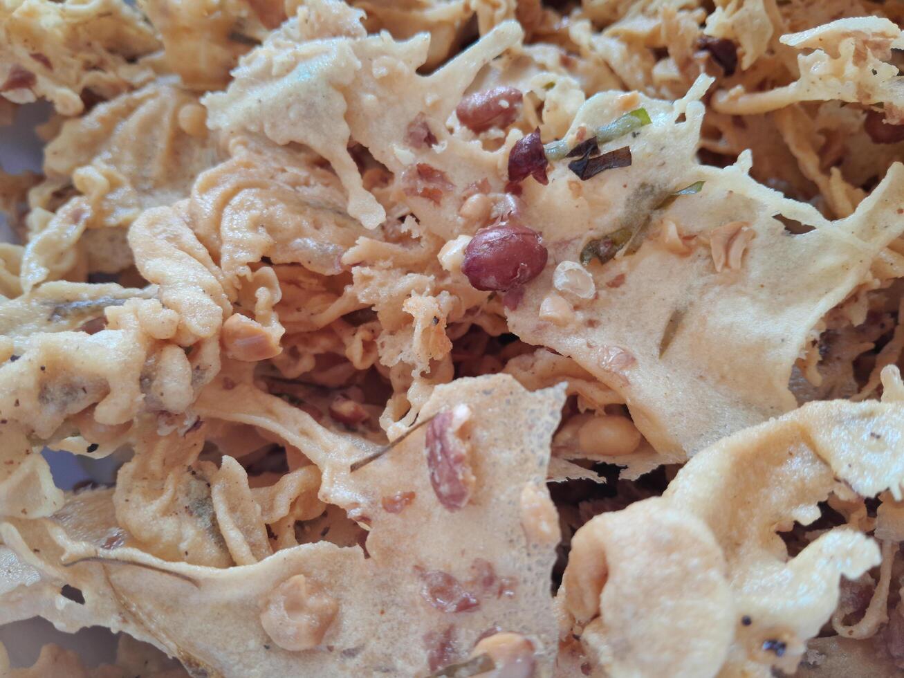 Photo of typical Indonesian food peanut brittle or Peyek, Rempeyek. This photo is perfect for food magazines, tabloid newspapers, food recipe books.