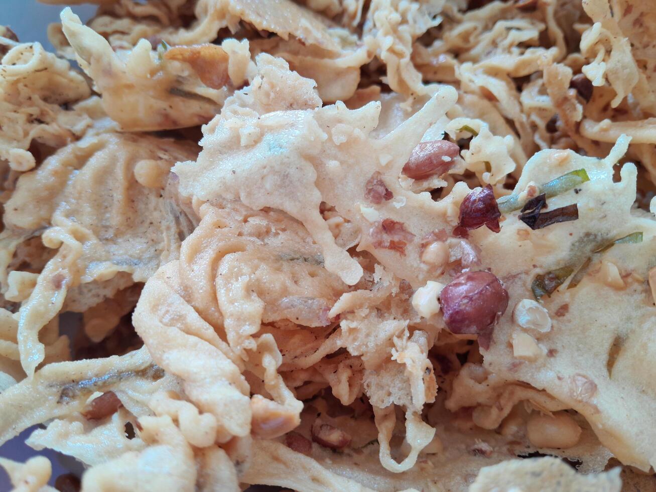 Photo of typical Indonesian food peanut brittle or Peyek, Rempeyek. This photo is perfect for food magazines, tabloid newspapers, food recipe books.