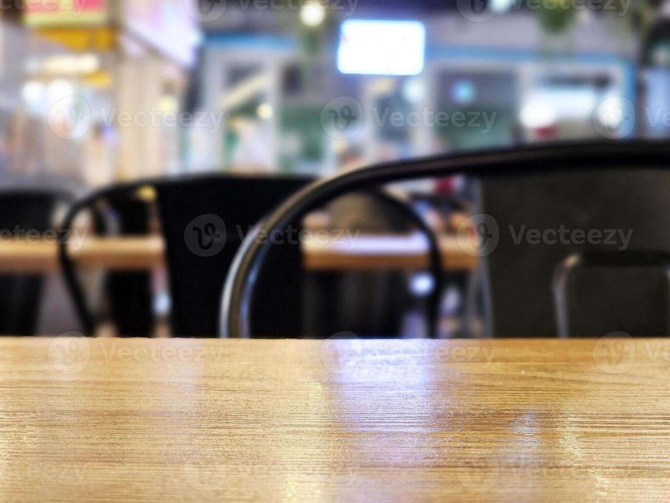 Close up Surface of Wooden Table in Cafe with Bokeh Background. Selective Focus photo