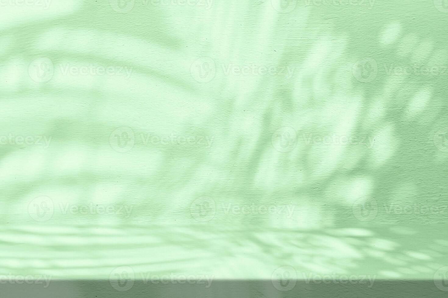 Stucco Table with Palms Shadow on Green Concrete Wall Texture Background, Suitable for Product Presentation Backdrop, Display, and Mock up. photo