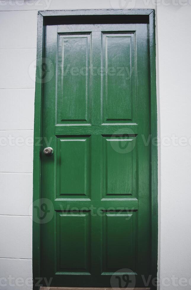 Green door wooden trance to house. photo